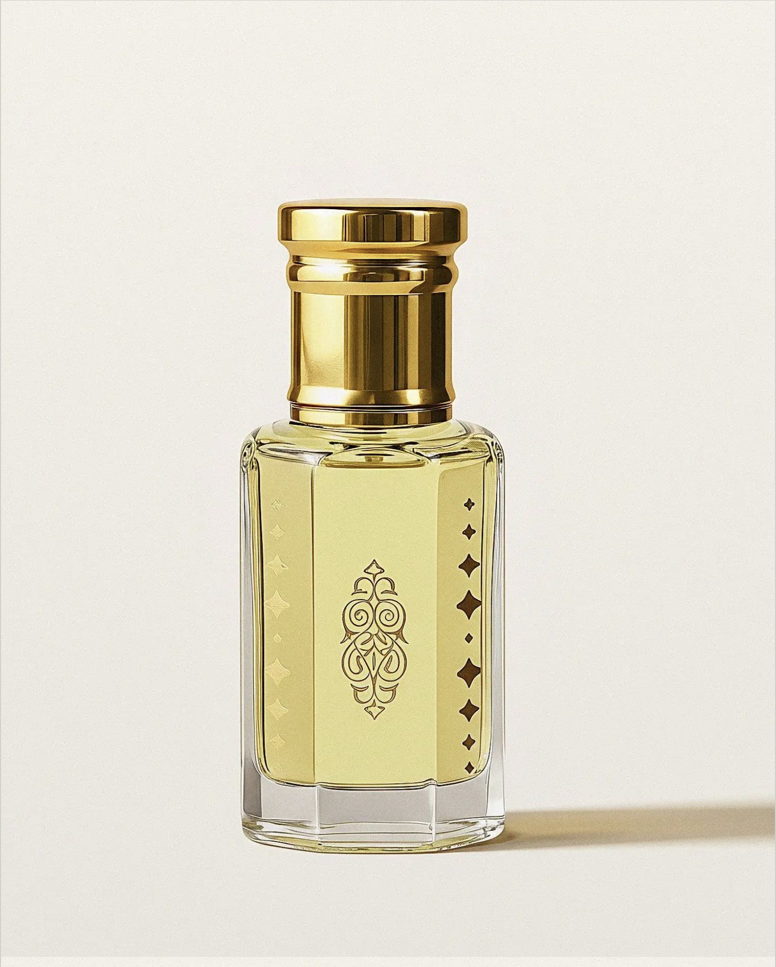 A gold-capped bottle of Aden perfume oil on a pale ground.